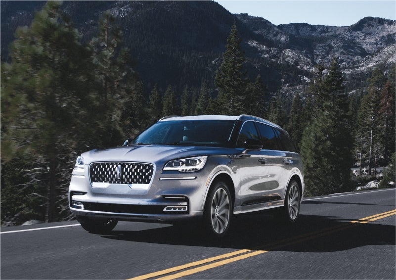 A 2023 Lincoln Aviator® Grand Touring SUV being driven on a winding road to demonstrate the capabilities of all-wheel drive | Lincoln of New Bern in New Bern NC