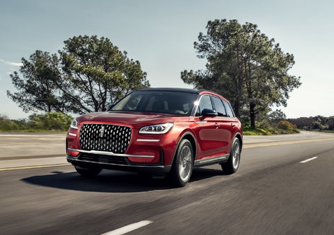 A 2026 Lincoln Corsair® SUV is shown being driven on a country road. | Lincoln of New Bern in New Bern NC