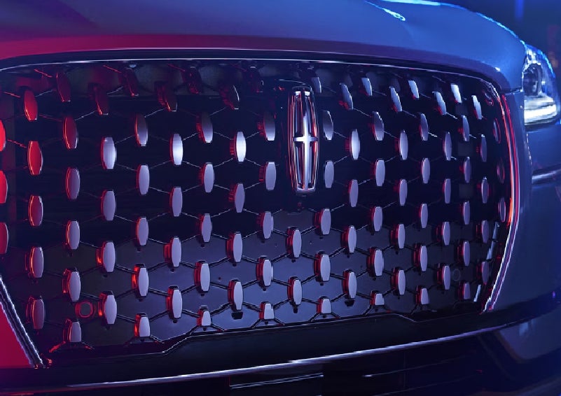 The grille of a 2025 Lincoln Corsair&reg; SUV reflects neon light at night. | Lincoln of New Bern in New Bern NC