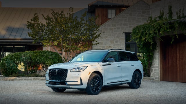 A 2026 Lincoln Corsair® SUV is parked in front off a luxury home. | Lincoln of New Bern in New Bern NC