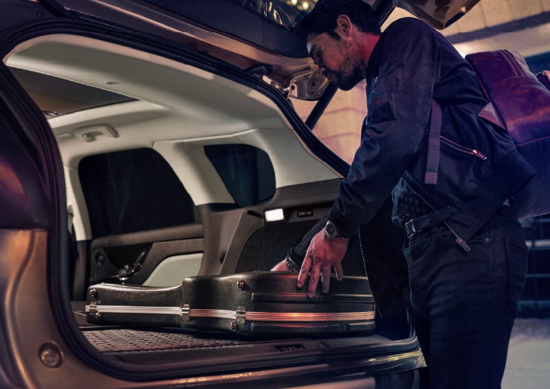 A man is shown loading cargo into the rear of a 2026 Lincoln Corsair® SUV with the second-row seats folded flat. | Lincoln of New Bern in New Bern NC