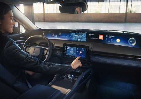 The driver of a 2026 Lincoln Nautilus® SUV interacts with the center touchscreen. | Lincoln of New Bern in New Bern NC