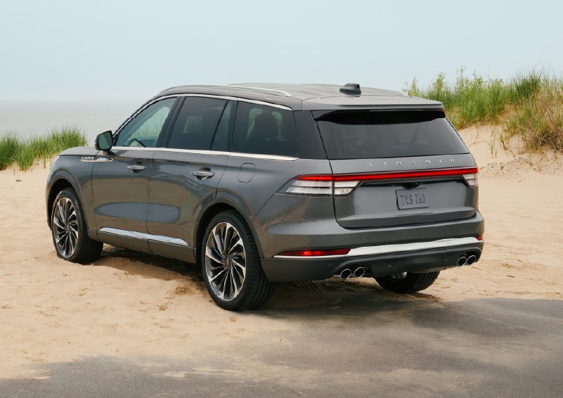 A 2027 Lincoln Aviator® SUV is parked next to sand dunes. | Lincoln of New Bern in New Bern NC