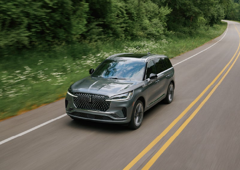 A 2027 Lincoln Aviator® SUV is being driven down a road. | Lincoln of New Bern in New Bern NC