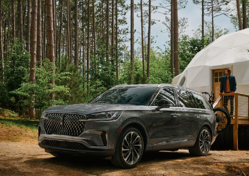 A 2027 Lincoln Aviator® is parked next to a high end glamping site. | Lincoln of New Bern in New Bern NC