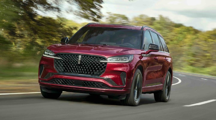 A 2027 Lincoln Aviator® SUV is being driven on a country road | Lincoln of New Bern in New Bern NC