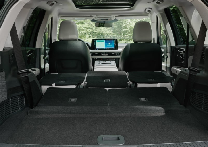 A rear to front view of the interior of a 2027 Lincoln Aviator® Black Label™ SUV shows the third and second rows folded flat | Lincoln of New Bern in New Bern NC