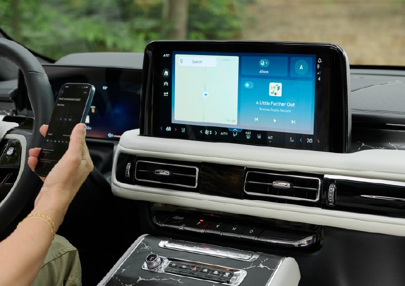 A person pairs thier phone with the center touchscreen of a 2027 Lincoln Aviator® Black Label™ SUV | Lincoln of New Bern in New Bern NC